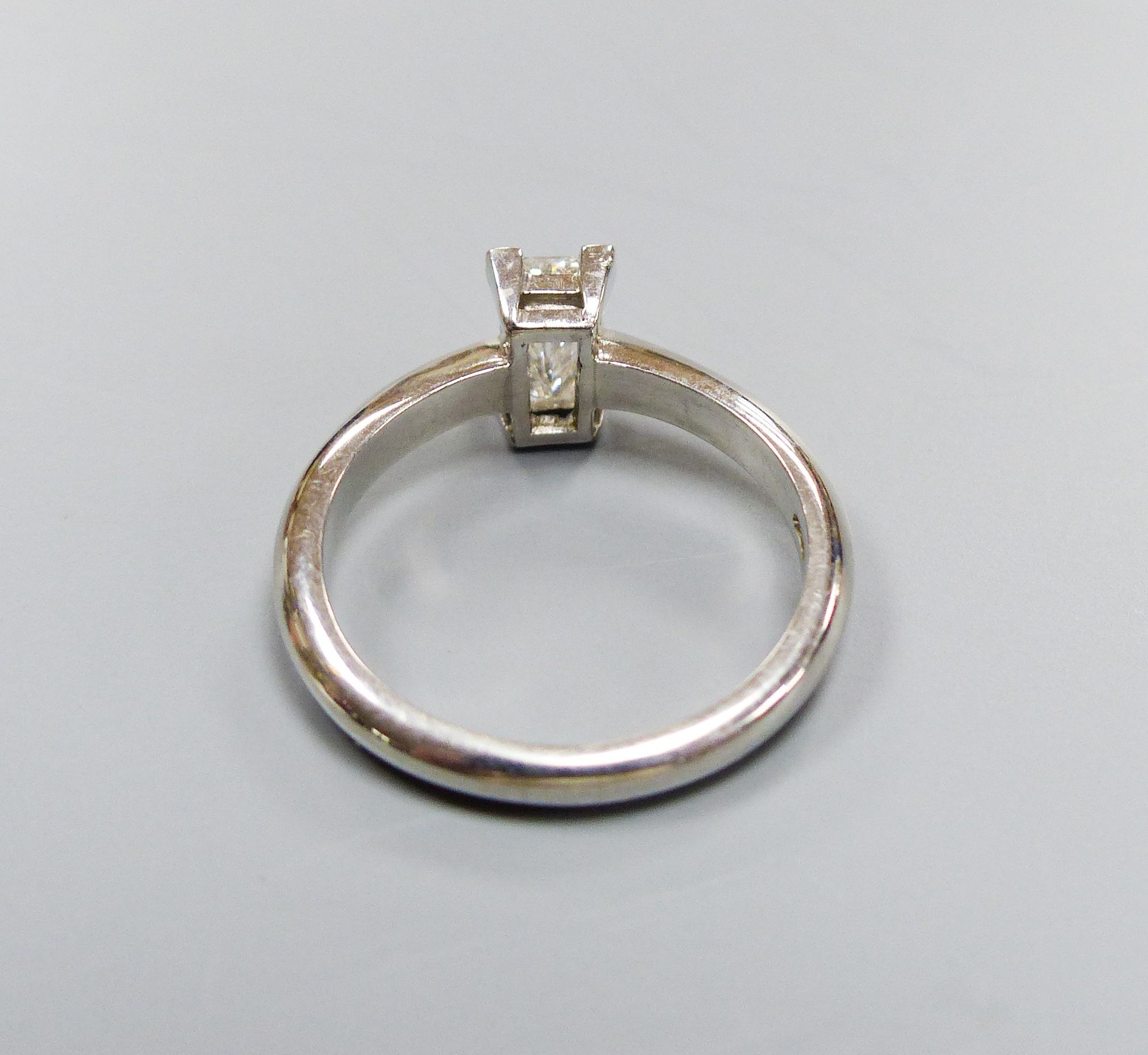 A modern platinum and solitaire rectangular cut diamond ring, size L, gross 4.5 grams